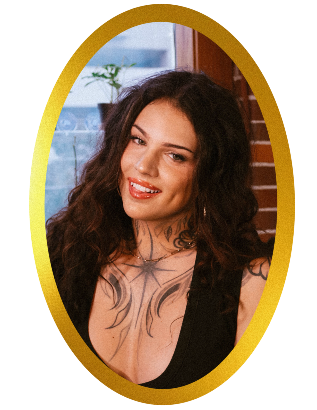 A photograph of artist Santiago Gonzales, a person with long, dark, curly hair, black and grey neck tattoos of a star and leaf vines. They are wearing a black tank top and a gold chain necklace. The photo is in a gold, oval frame.